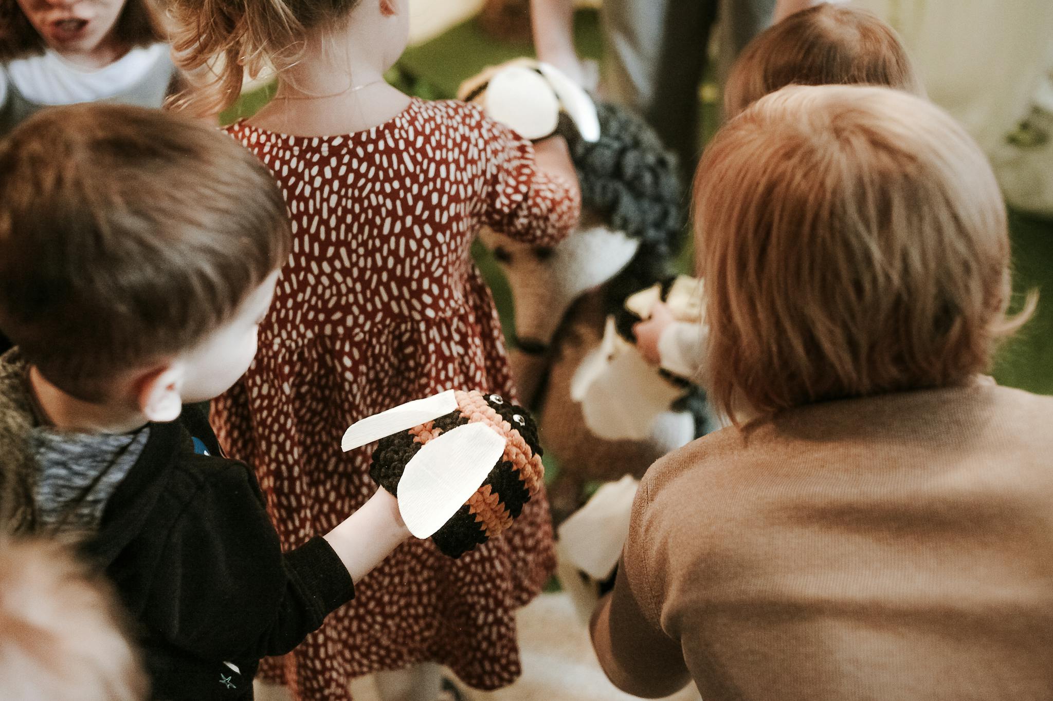 Group of children interacting playfully indoors during kindergarten activities.